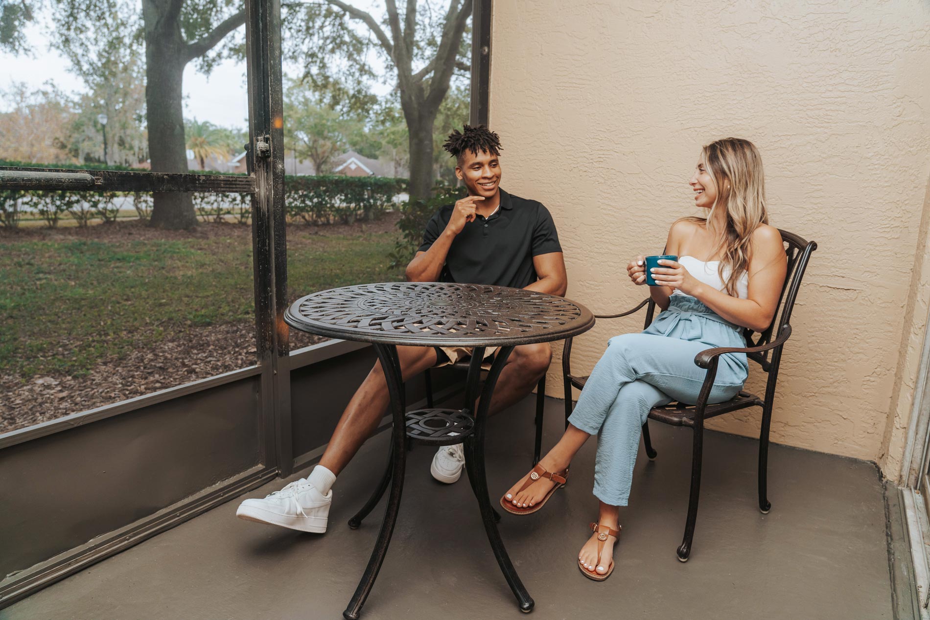 alafaya woods man and woman sit on patio with coffee