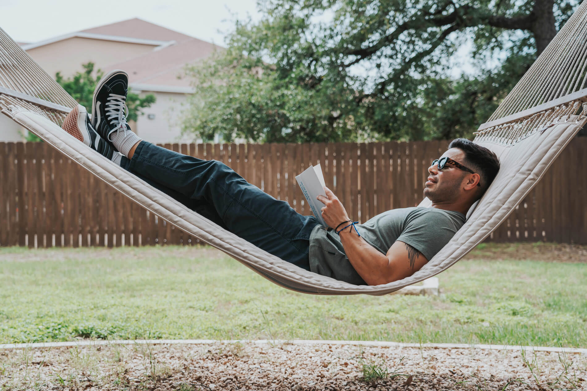 Lakeline Villas man lays on hammock and reads