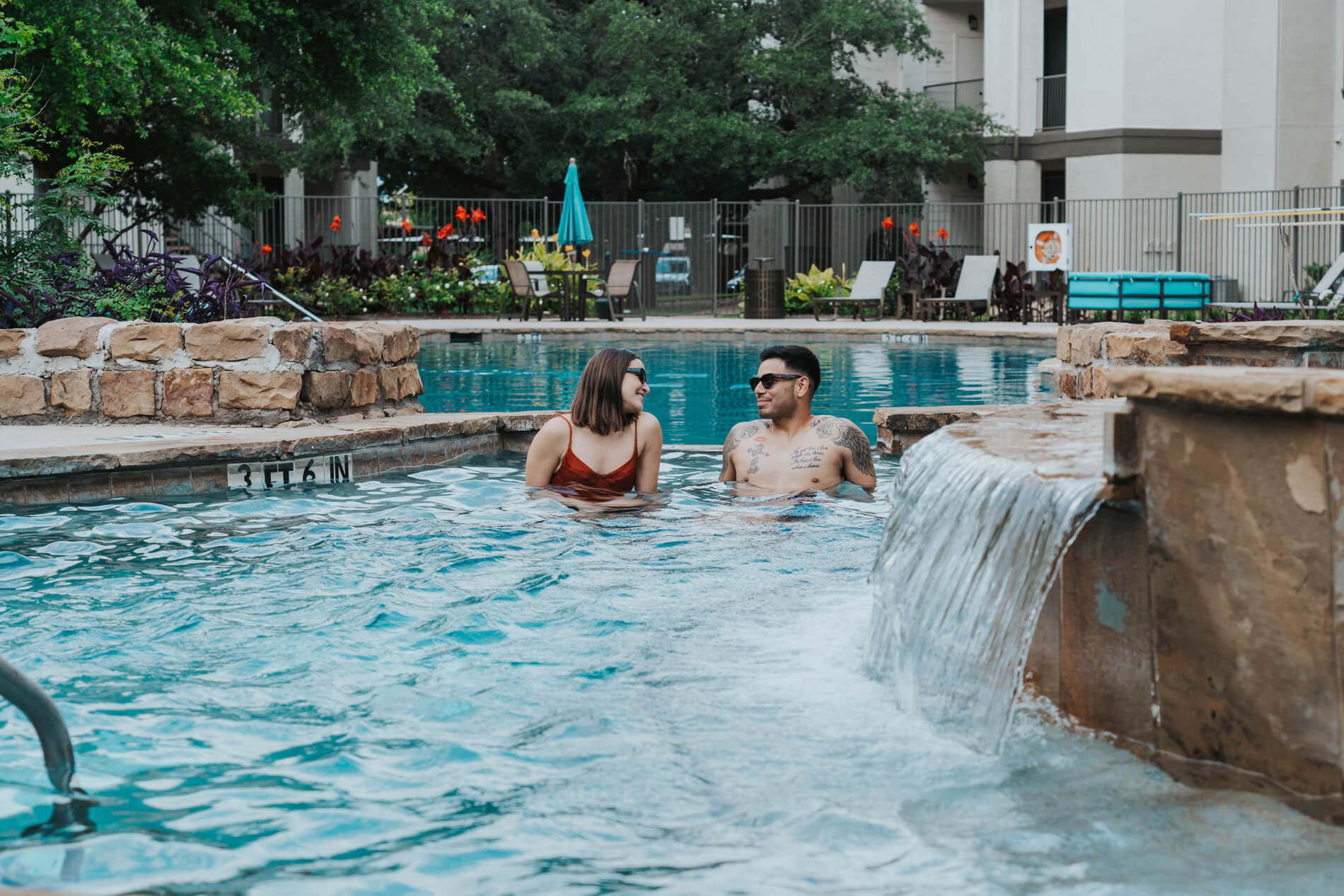 Lakeline Villas man and woman sit in pool