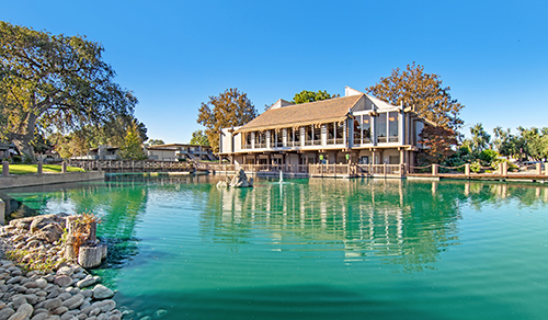 Marina Playa building exterior and pond