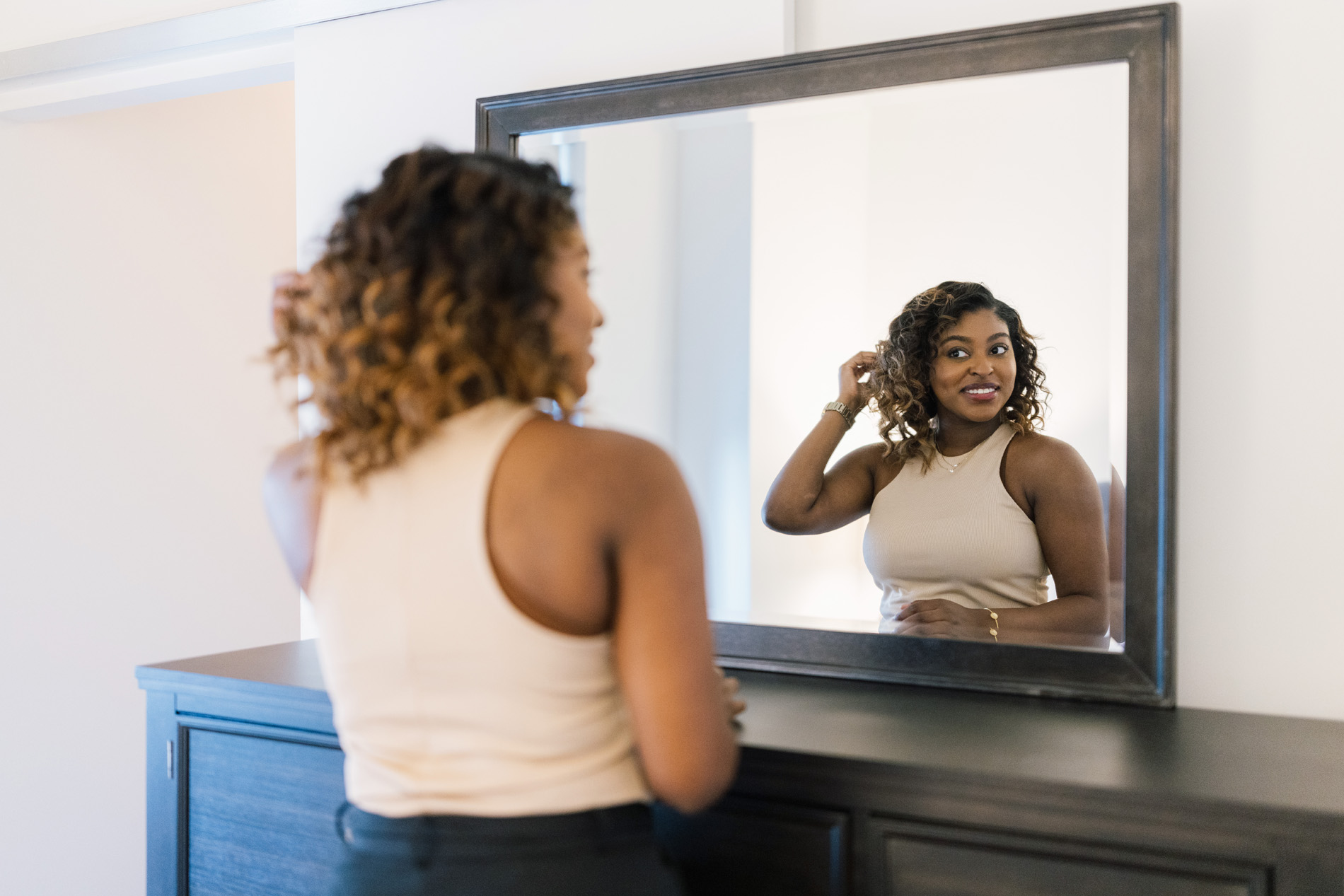 View 14 woman does hair in mirror