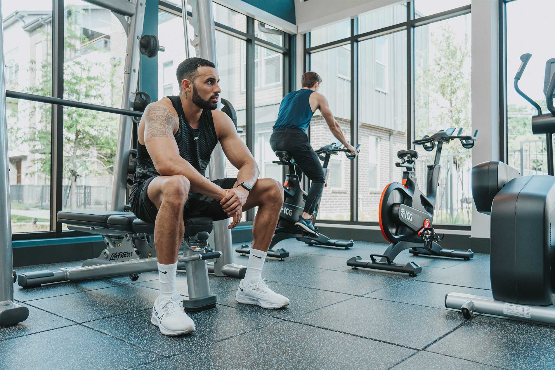 Two young men working out in fitness center