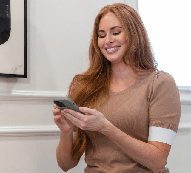 ChatCard Woman smiling using phone min